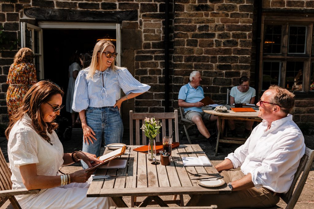 The Peacock at Rowsley in the sunshine for cocktails on the terrace or outdoor dining. Fine dining restaurant and hotel Derbsyhire Peak District Bakewell near Chatsworth