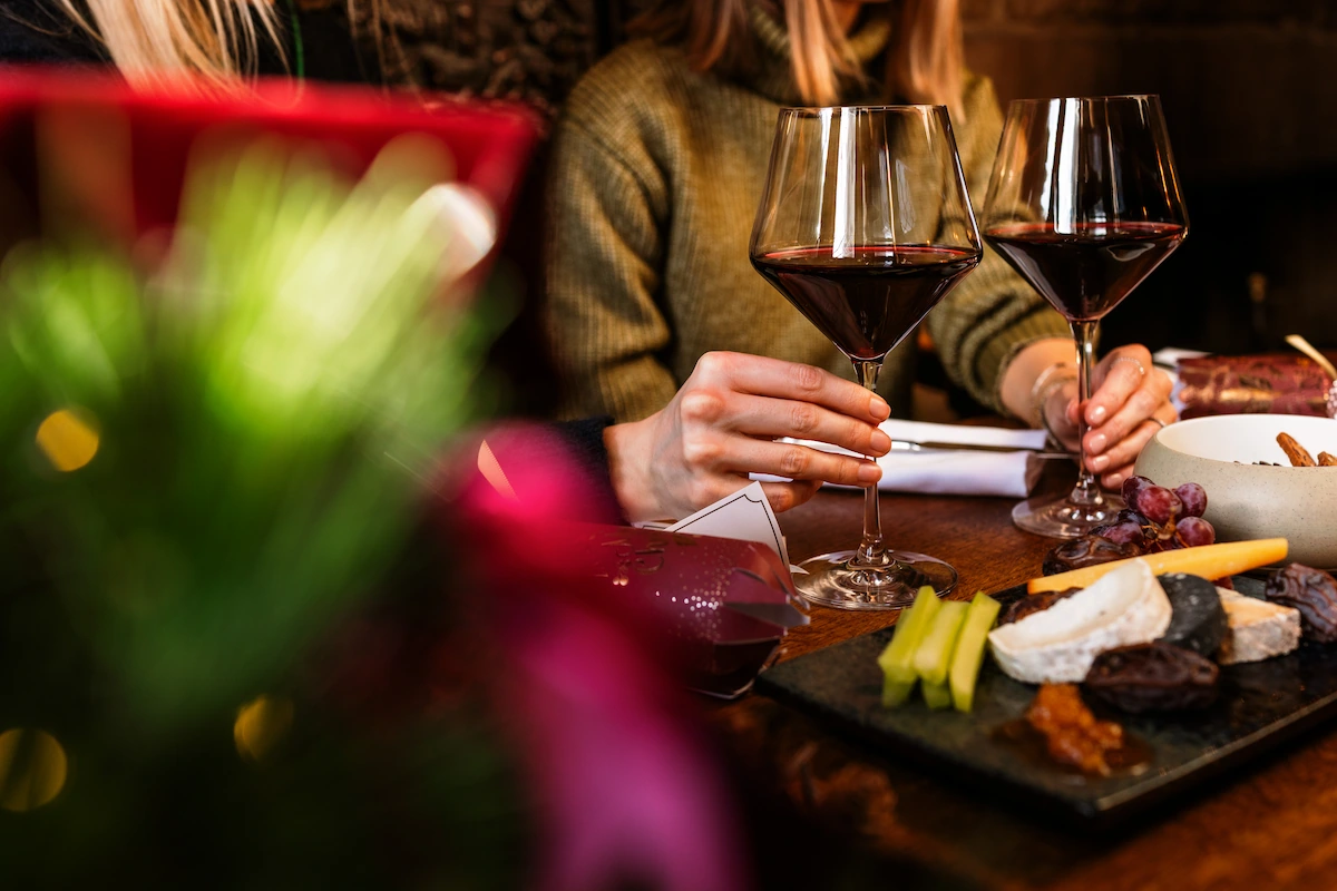 Two glasses of red wine with a cheese board at The Peacock at Rowsley