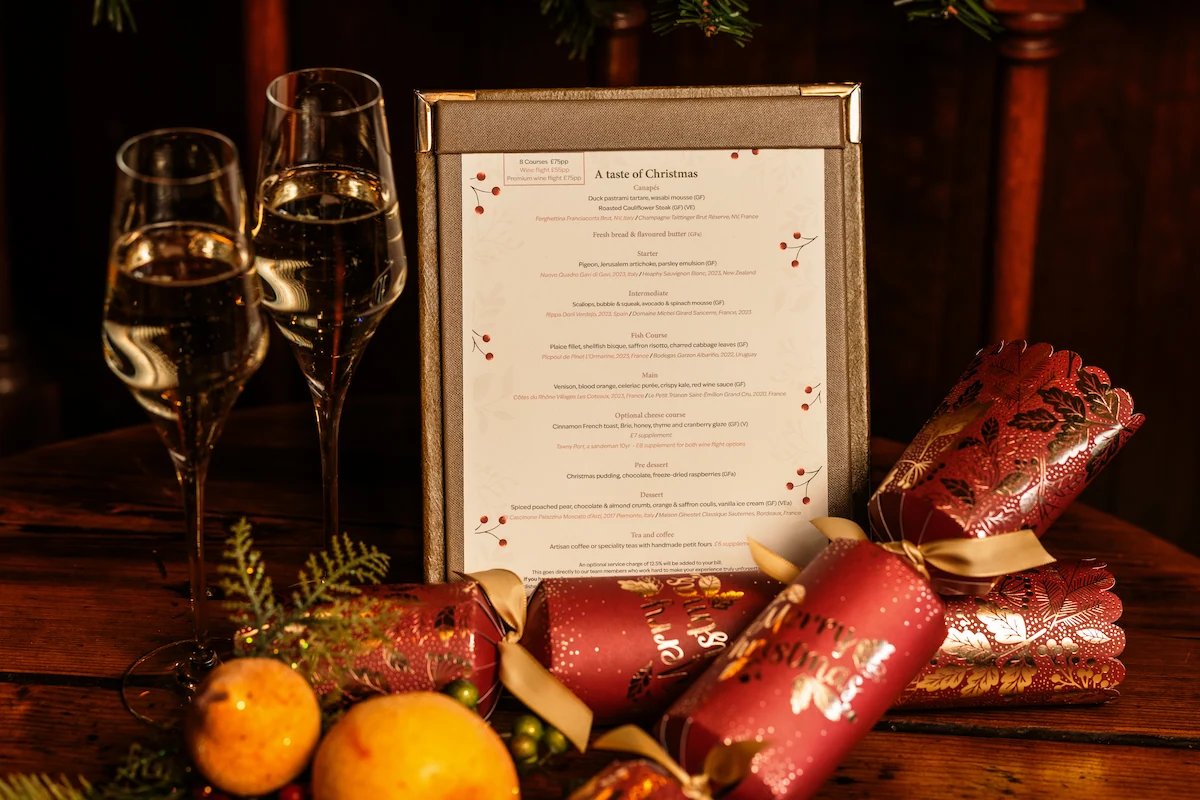 The taste of Christmas menu shown with crackers and glass of fizz